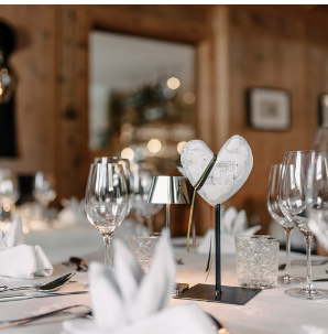 An elegant gala menu and a wine tasting are being advertised. The image shows an appealing arrangement of dishes and wines in a festive setting.
